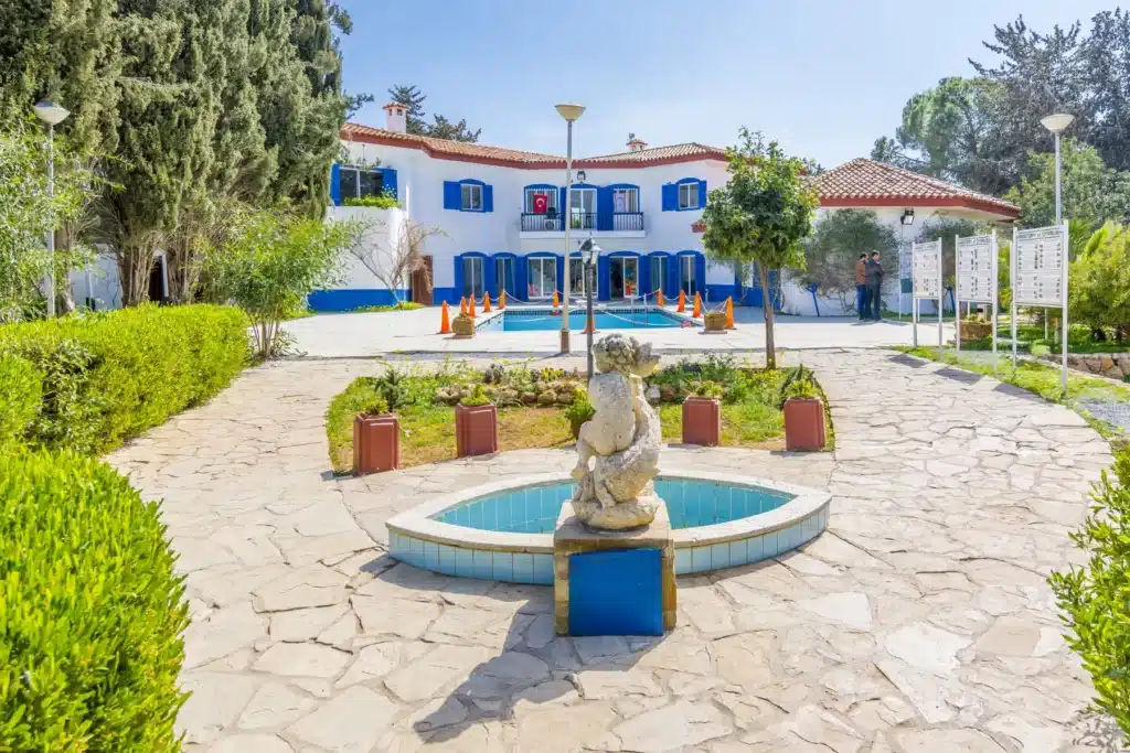 a building with a pool and a statue in front of it